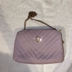 Purple cross body bag with gold straps and many pockets.